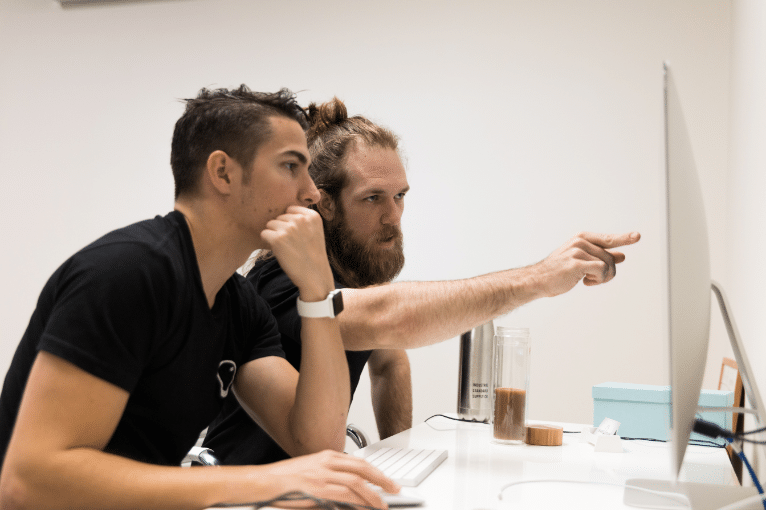 image of two blokes pointing at an iMac computer screen
