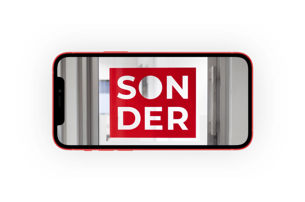 an iPhone 12 that features the Sonder logo